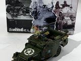 a toy army vehicle that is sitting in front of a box