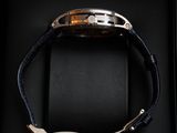 a watch in a black box on a black surface