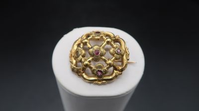a close up of a gold ring on a white surface