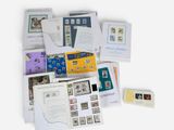 many different types of stamps and envelopes laid out on a table