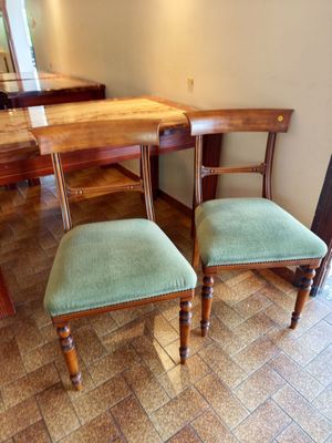 two chairs that are next to a table in a room