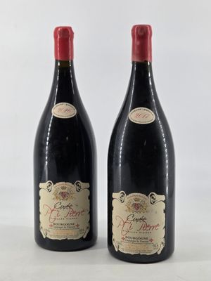 two bottles of red wine sitting next to each other on a table
