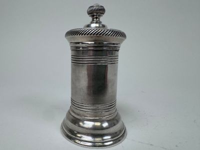 an antique silverplated salt shaker on a white background