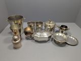 an assortment of silverware on a table in a room