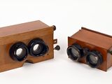 two wooden cameras sitting next to each other on a white surface