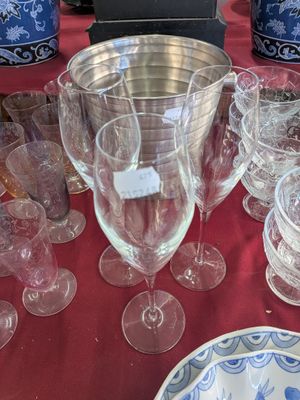 a table with a bunch of wine glasses and plates on it