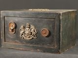 une petite boîte en métal sur laquelle est représenté un blason