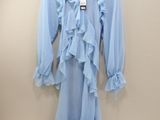 light blue long sleeved dress with ruffles on a hanger