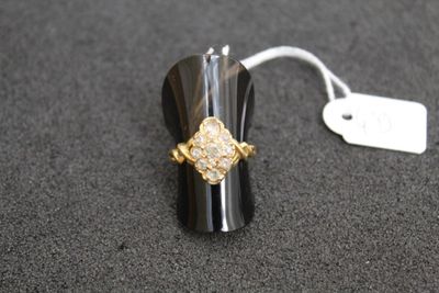 a ring that is sitting on a table with a price tag attached to it
