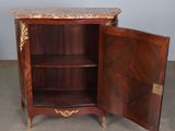 a small cabinet with a marble top and a door open