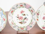three plates are sitting on a wooden stand on a table