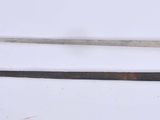 two different types of swords on a white surface