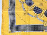 a yellow scarf with a blue and gold design