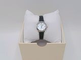 a watch in a box with a pillow on it