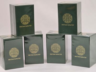 six green boxes with gold logos are stacked on top of each other