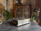 a small metal box sitting on top of a table