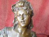 a statue of a woman that is sitting on a red chair
