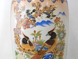 a large vase with birds and flowers on it