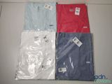 four different colored t - shirts are sitting on a white surface
