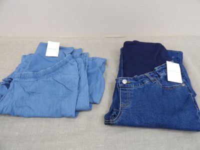 two pairs of blue jeans sitting on top of a table