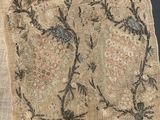 an old piece of cloth with a design of birds and flowers