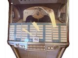 a juke box with a clock on the front