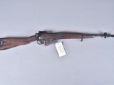 a rifle that is on display on a white surface