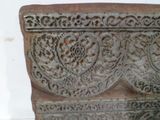 a stone vase that has a design on the side of it