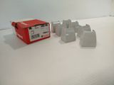 a red box with several pieces of metal on a white surface