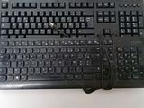 a black keyboard and mouse on a white table