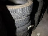 several tires are stacked on top of each other in a garage