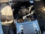a trash can in the center of a car ' s dashboard