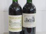 two bottles of wine sitting next to each other on a table