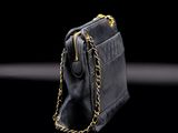 an image of a black purse on a black background