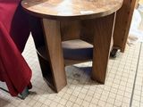 a small table that is on the floor next to a bed