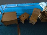 three wooden chairs and a table in a room