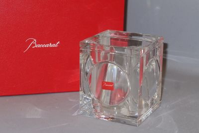 a red box and a clear glass candle holder on a table