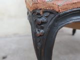a close up of a chair with a floral upholstered on it