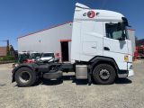 a picture of a white truck parked in front of a building