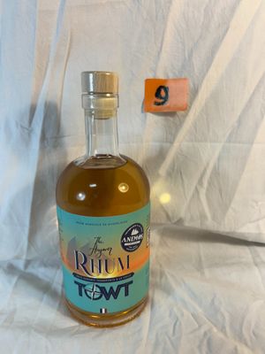 a bottle of liquor sitting on a white sheet