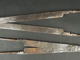 three old metal tools are sitting on a table