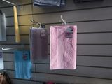 many towels hanging on a wall in a store