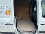 a white van with the door open on a parking lot