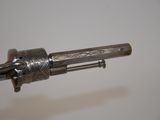 a metal object that is on a white surface