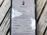iphone xr with a broken screen sitting on a wooden table