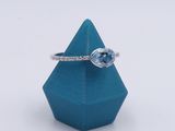 a close up of a blue ring with a diamond on top of it