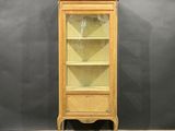 a wooden cabinet with a glass door on top of a wooden floor