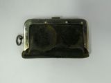a black purse that is sitting on a white table
