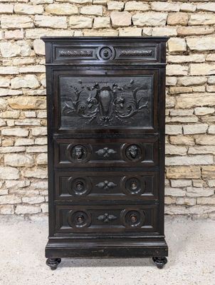 an old wooden chest of drawers with carvings on top of it