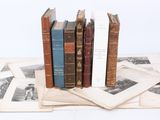 several old books are stacked on top of each other on a table